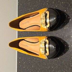 Yellow and black kitten heel pumps